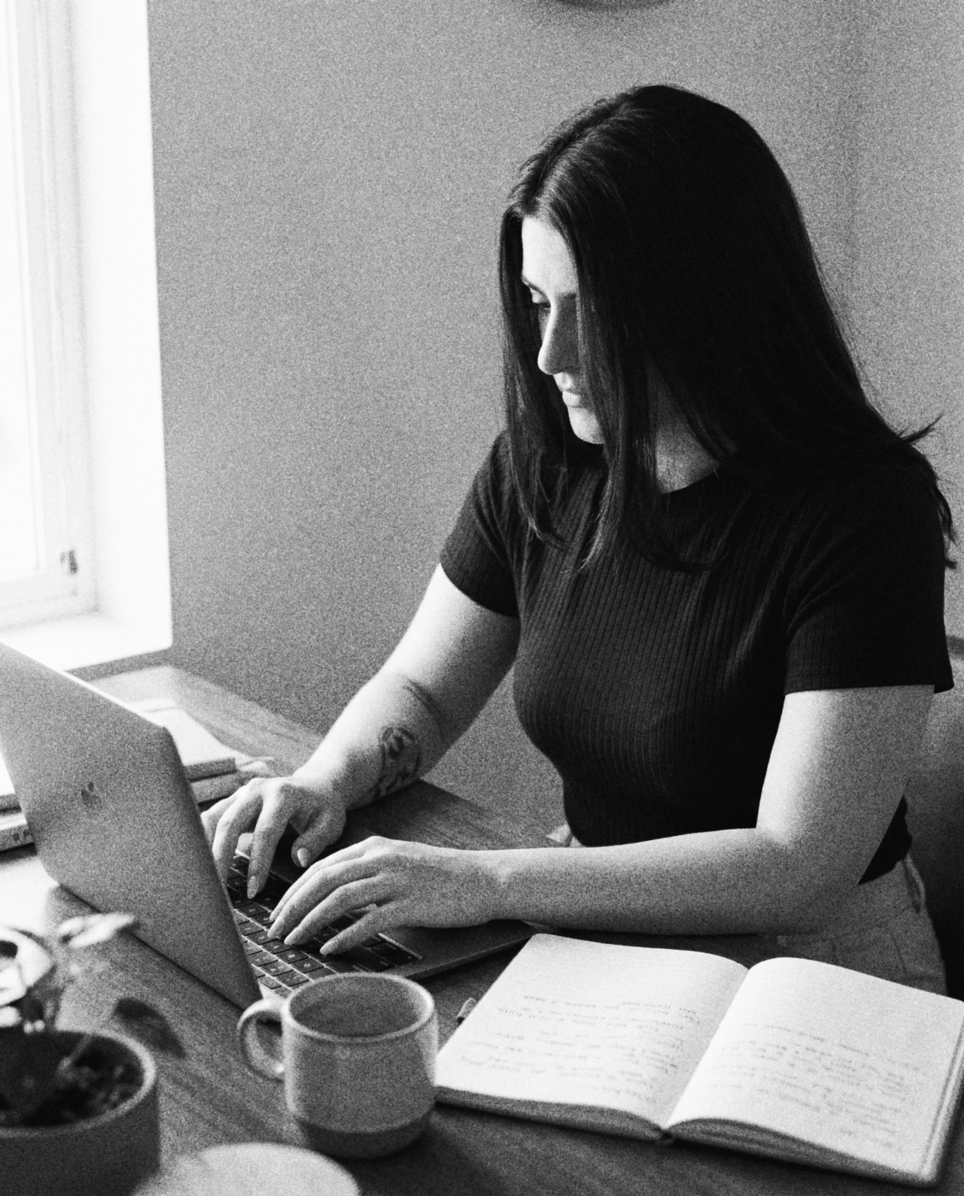 Meg working at her laptop